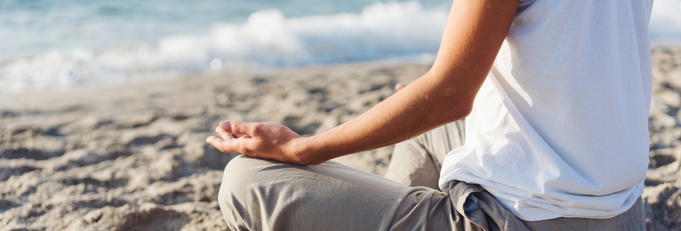 body of a beautiful girl in a meditation on the beach